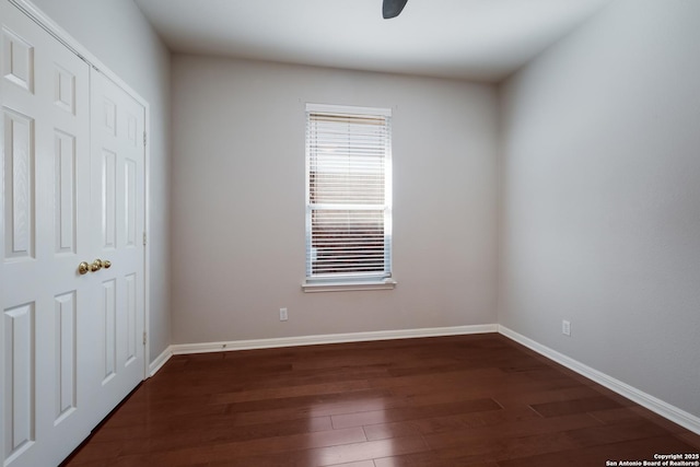 unfurnished bedroom featuring ceiling fan and dark hardwood / wood-style floors