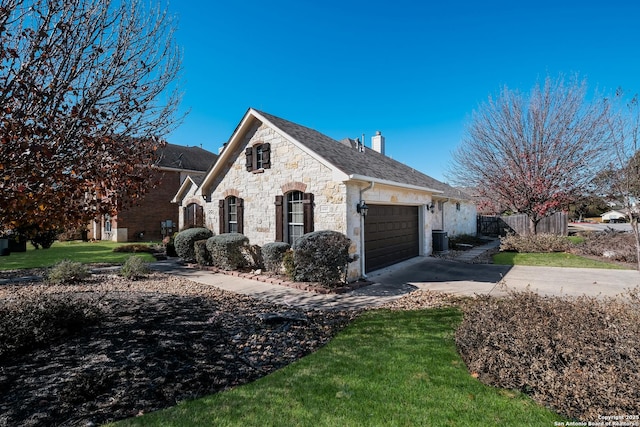 view of property exterior featuring central AC unit, a garage, and a lawn