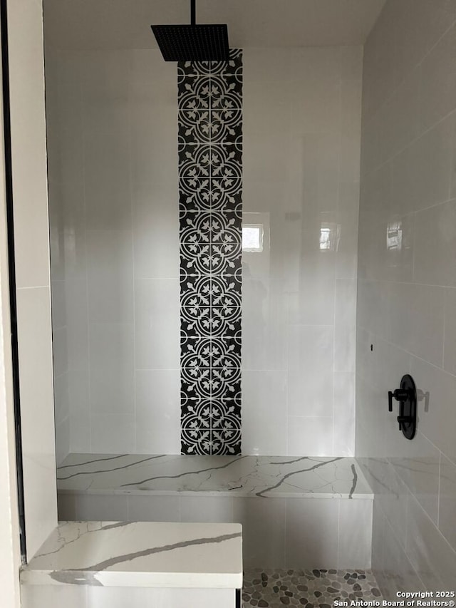 bathroom with a tile shower