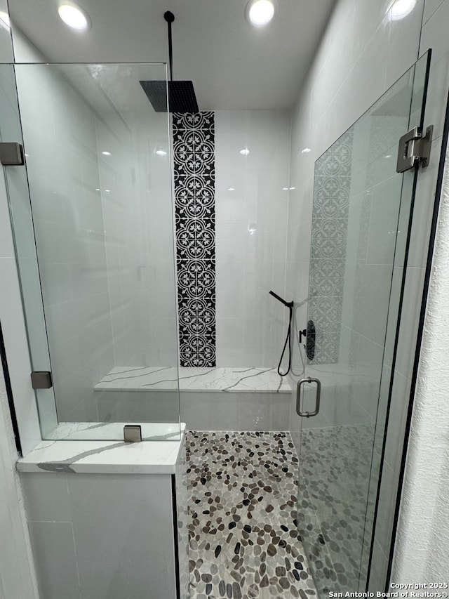 bathroom with a shower with shower door