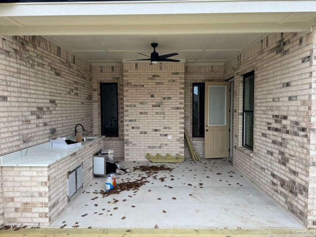 view of patio with ceiling fan and sink