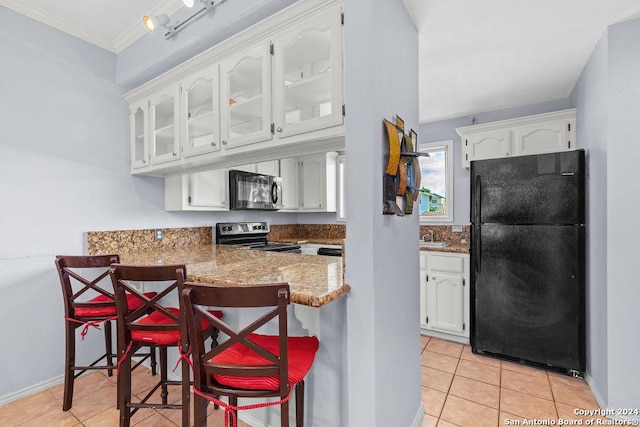 kitchen featuring light tile patterned floors, kitchen peninsula, white cabinets, a breakfast bar, and black appliances