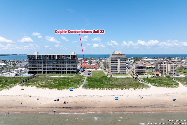 bird's eye view featuring a water view and a beach view