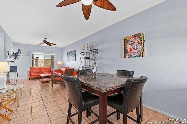 tiled dining room with ceiling fan and crown molding