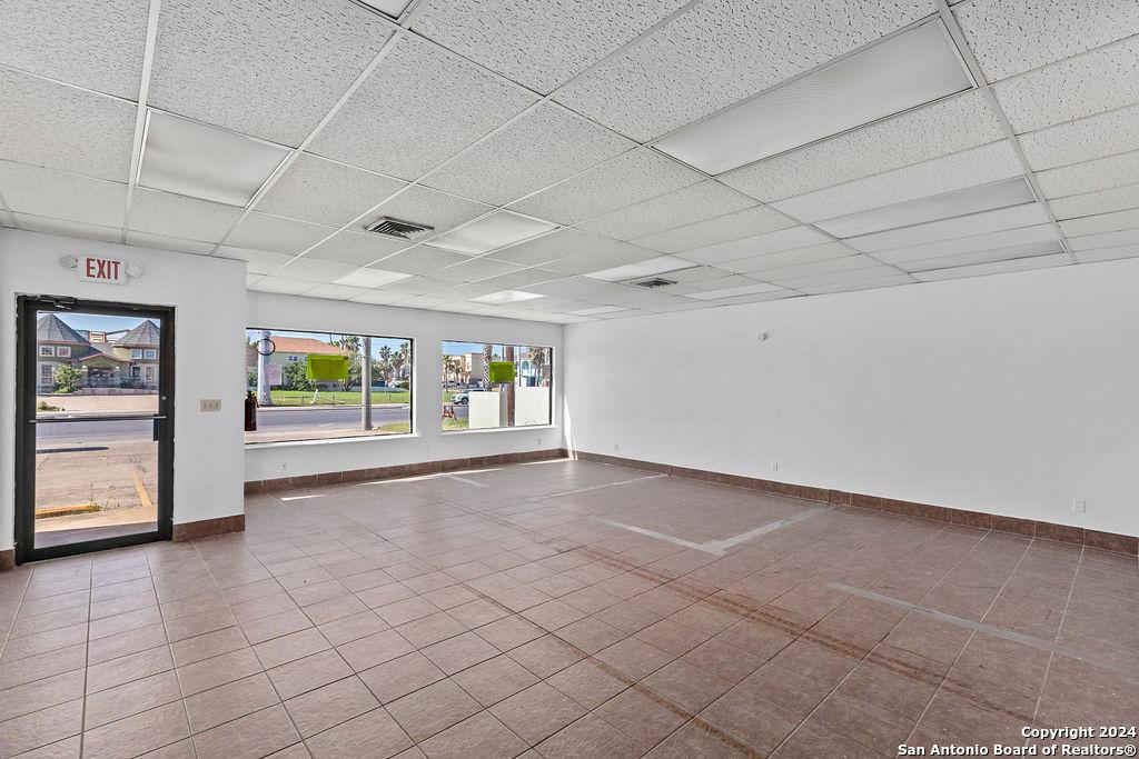 unfurnished room with a drop ceiling