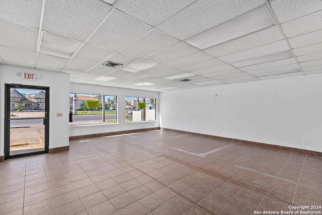 unfurnished room with a drop ceiling