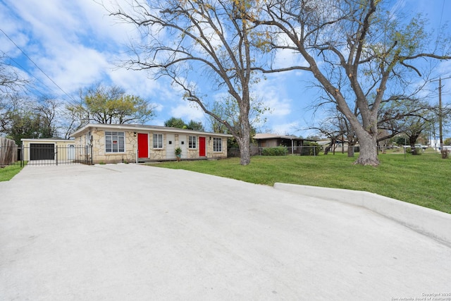 ranch-style home featuring a garage and a front lawn