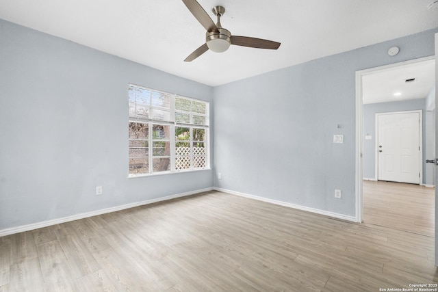 spare room with ceiling fan and light hardwood / wood-style floors