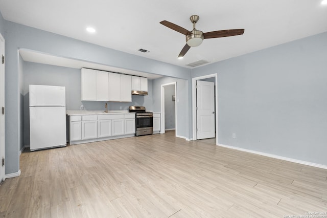 kitchen with ceiling fan, white fridge, sink, white cabinetry, and stainless steel range