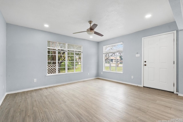 spare room with ceiling fan and light hardwood / wood-style floors