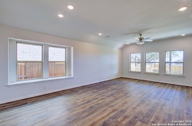 empty room with vaulted ceiling, ceiling fan, and hardwood / wood-style flooring