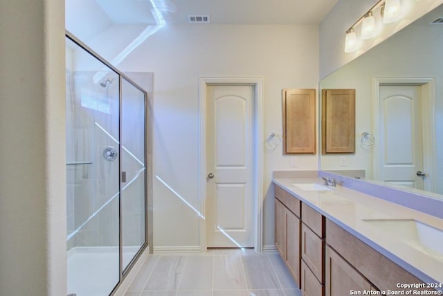 bathroom featuring walk in shower and vanity