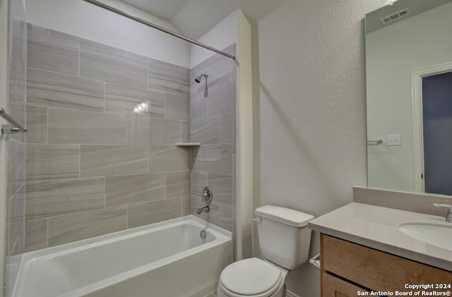 full bathroom featuring toilet, vanity, and tiled shower / bath