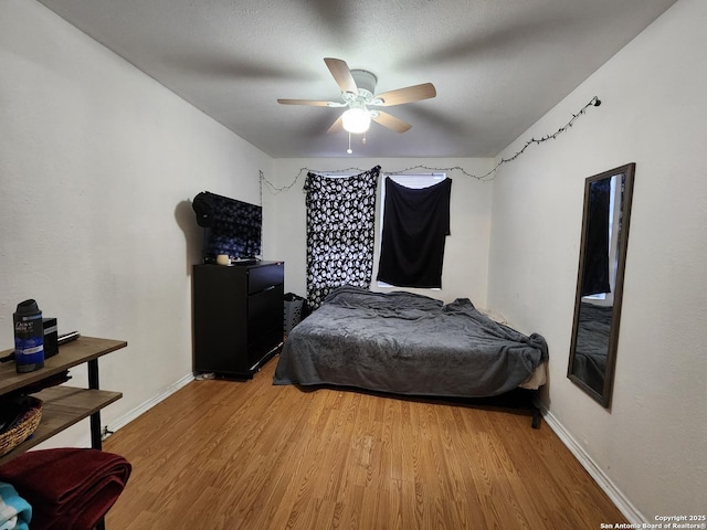 bedroom with wood-type flooring and ceiling fan