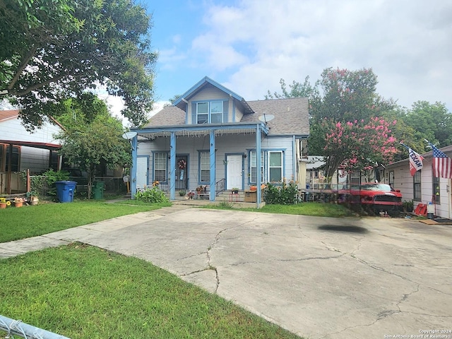 bungalow with covered porch and a front yard