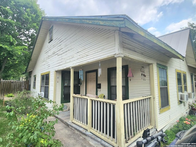 view of side of property with cooling unit and a porch