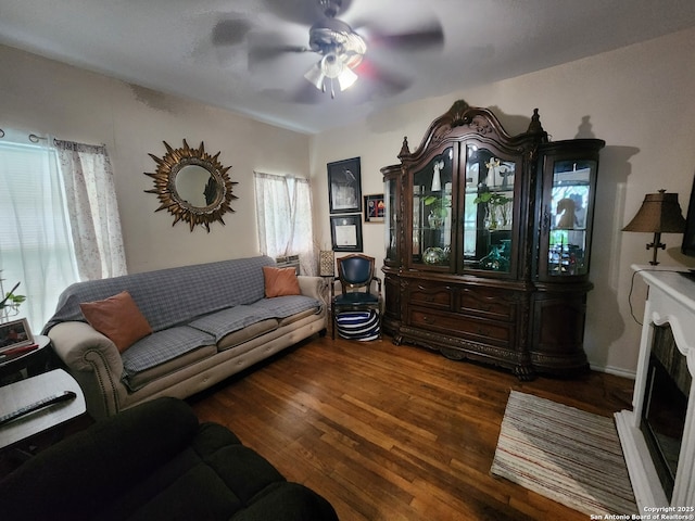 living room with ceiling fan and dark hardwood / wood-style flooring