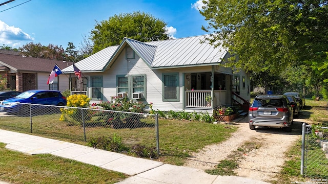 bungalow-style house with a porch and a front lawn