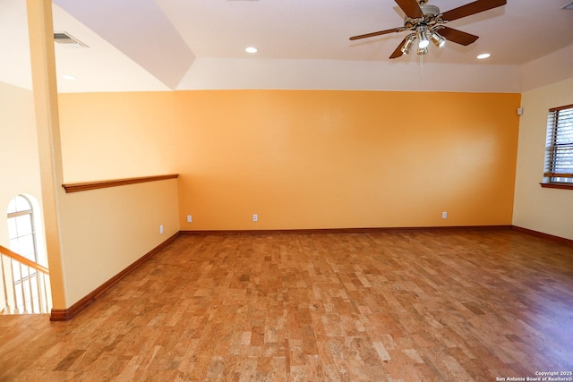 empty room with ceiling fan and light hardwood / wood-style flooring