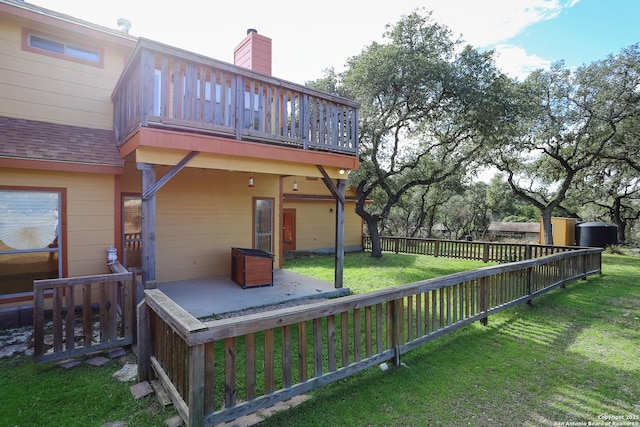 wooden deck with a lawn and a patio