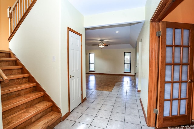 interior space with tile patterned floors and ceiling fan