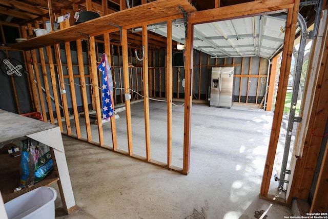 basement with stainless steel fridge