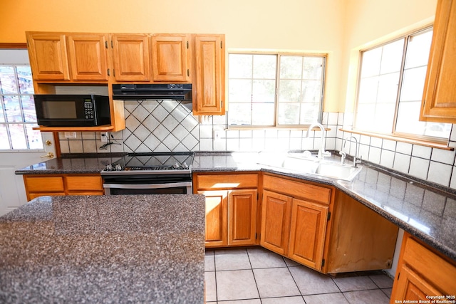 kitchen with light tile patterned floors, stainless steel electric range, sink, range hood, and tasteful backsplash