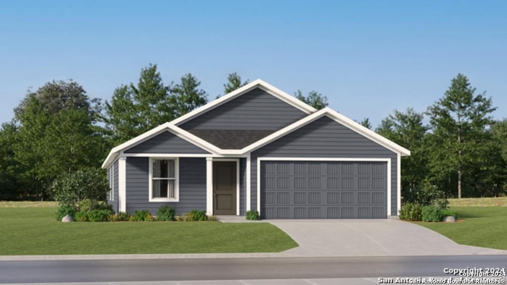 view of front of property with a front lawn and a garage