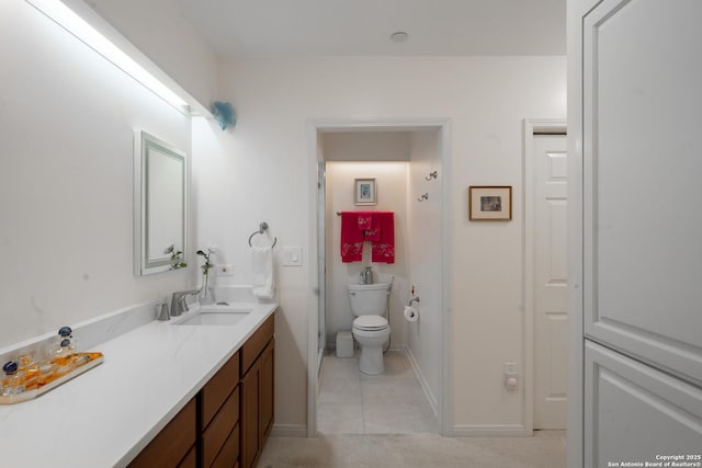 bathroom featuring tile patterned flooring, vanity, and toilet