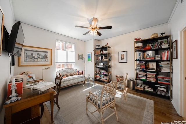 living area featuring hardwood / wood-style flooring and ceiling fan