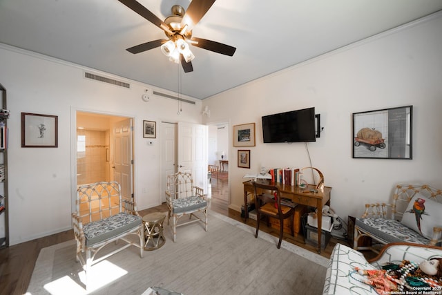 sitting room with wood-type flooring and ceiling fan