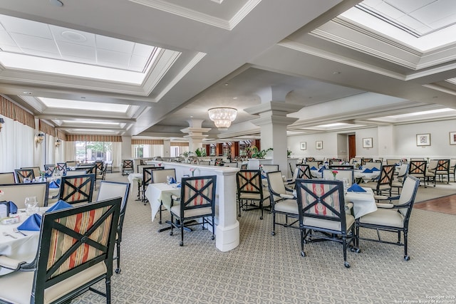 dining area with ornate columns, ornamental molding, and light colored carpet