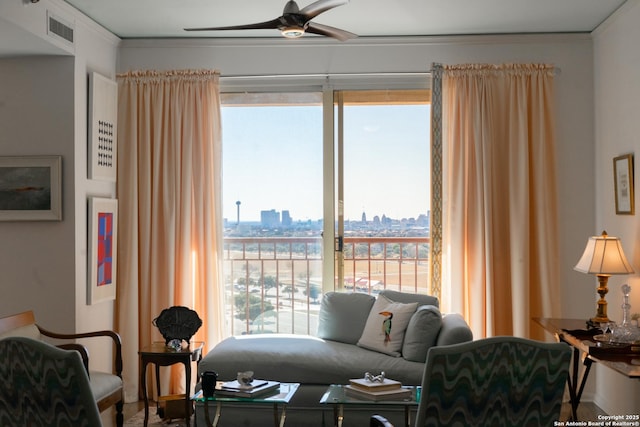 living room featuring ceiling fan and a healthy amount of sunlight