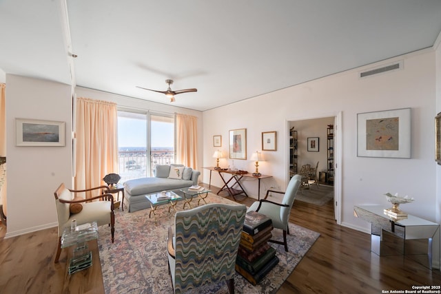 living room featuring ceiling fan and hardwood / wood-style floors