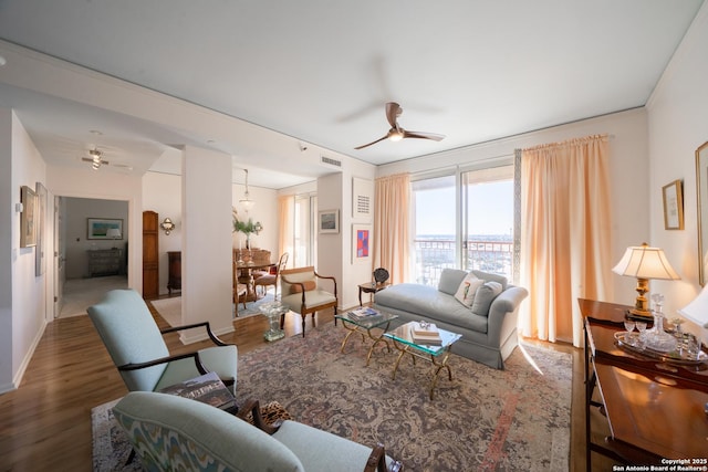 living room with hardwood / wood-style flooring and ceiling fan