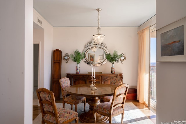 dining room with a chandelier and light hardwood / wood-style floors