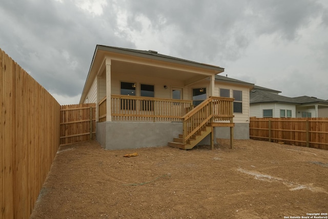 8321 Roadrunner Psge, San Antonio, TX 78222 - back of house with stairway and a fenced backyard