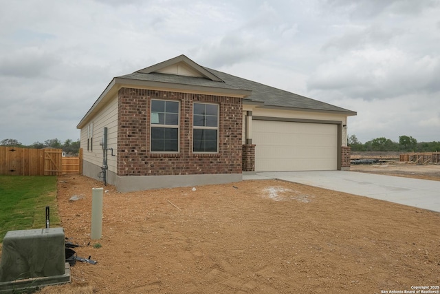 8321 Roadrunner Psge, San Antonio, TX 78222 - view of front of property with driveway, fence, an attached garage, and brick siding