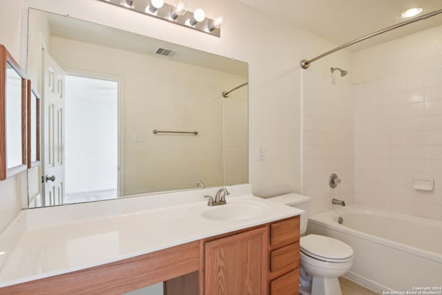 full bathroom featuring vanity, toilet, and tiled shower / bath