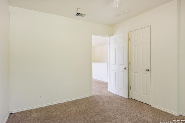 empty room featuring light colored carpet