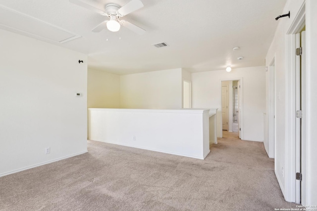 carpeted spare room featuring ceiling fan