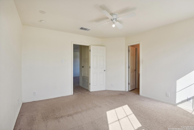 unfurnished bedroom with ceiling fan and light carpet