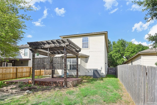 back of property featuring a wooden deck, cooling unit, a yard, and a pergola