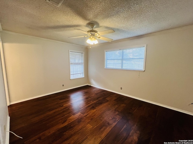 spare room featuring a textured ceiling, ceiling fan, dark hardwood / wood-style flooring, and ornamental molding