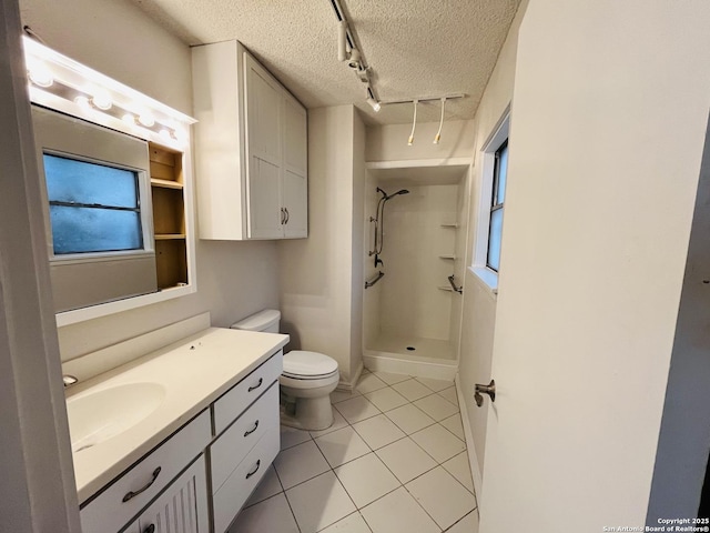 bathroom with a textured ceiling, tile patterned flooring, vanity, a shower, and toilet