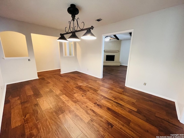 unfurnished dining area with a fireplace and wood-type flooring