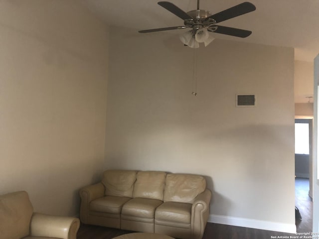 living room featuring ceiling fan and dark hardwood / wood-style floors