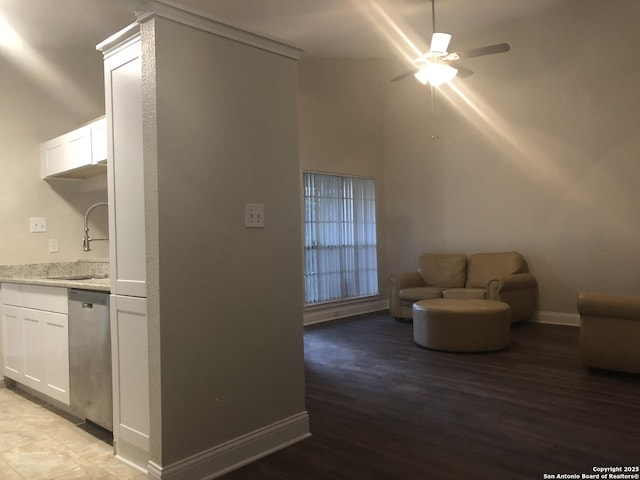 interior space featuring ceiling fan, sink, and light wood-type flooring