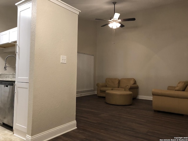 unfurnished living room with ceiling fan, ornamental molding, dark hardwood / wood-style floors, and sink