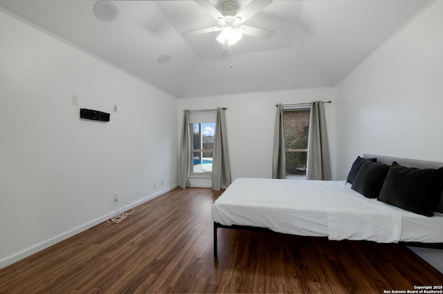 bedroom featuring ceiling fan, dark hardwood / wood-style flooring, and a raised ceiling